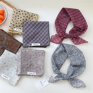 Polka dot and paisley cotton linen scarves displayed flat for summer outfit styling