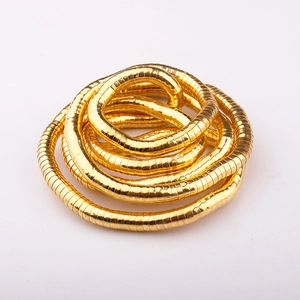 Close-up of flexible golden snake-bone chain with intricate metallic interlocking segments