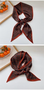 Close-up of brown silk scarf with paisley patterns and polka dots for neck wear