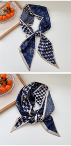 Detail of navy blue and beige paisley patchwork silk scarf with houndstooth pattern