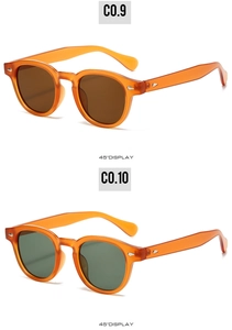 Détail de lunettes de soleil ovales oranges avec rivets et verres teintés vintage