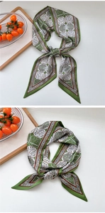 Detail of satin scarf featuring green geometric patterns and botanical print texture
