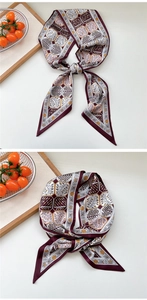 Macro detail of wine red cashew print silk scarf with geometric honeycomb patterns