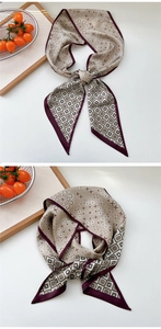 Detailed view of champagne silk scarf with paisley pattern and burgundy border finish