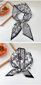 Detail of paisley and geometric chain pattern on vintage long skinny silk scarf