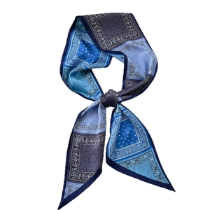 Blue paisley silk-like neckerchief with elegant patterns and a stylish knotted design