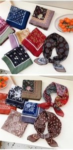 Detailed flat lay of diverse vintage paisley and floral print small square neck scarves