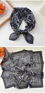 Detail of a black and white paisley floral silk scarf with elegant butterfly patterns
