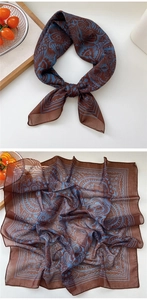 Detail view of the fine butterfly pattern on a square silk scarf for women