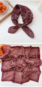 Detailed view of wine red silk scarf featuring intricate butterfly and floral patterns