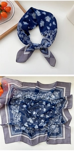 Close-up of a floral silk-feel scarf featuring navy blue patterns and grey border details