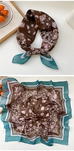 Detailed close-up of a floral silk scarf with dark brown base and blue geometric border