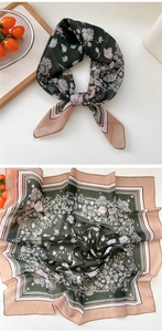 Detail of elegant green floral silk scarf with lace patterns and soft pastel borders