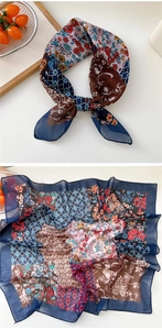 Detail of colorful floral and geometric print silk scarf with navy blue hemmed edges