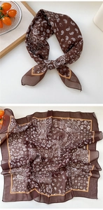 Detailed macro view of brown paisley silk scarf with delicate floral pattern and yellow edges