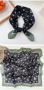 Detail of blue cashew floral silk scarf with vertical stripes and green border accent
