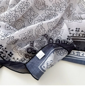 Detailed macro view of black and white floral heart print on a soft polyester scarf