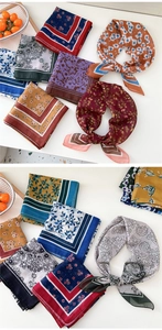 Detailed view of assorted floral silk scarves in vintage patterns and vibrant colors