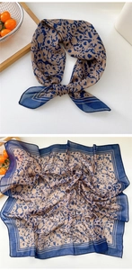 Close-up of lightweight navy blue floral silk square scarf with delicate rolled edges