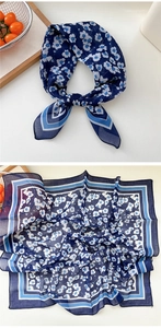 Detail of navy blue square floral silk scarf with geometric border and knot styling