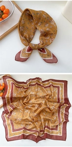 Detail of floral ginger yellow silk scarf tied as a bow showing vintage pattern and texture