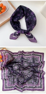 Detailed texture of purple floral silk scarf with elegant geometric border design