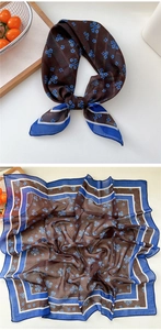 Close-up of floral square silk scarf featuring blue patterns and dark blue border