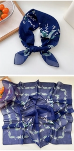 Detailed view of dark blue floral silk scarf with lily of the valley pattern print
