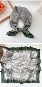 Detail of floral paisley silk scarf in dark green and beige with flat lay view