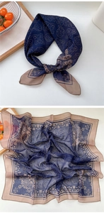 Close-up of vintage floral paisley pattern and delicate hem on blue square silk scarf