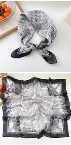 Detail of floral paisley print on a light black and white chiffon square scarf accessory