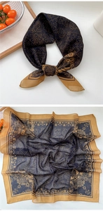 Close-up of floral paisley silk scarf in vintage gold and navy blue colors