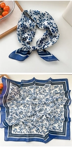 Detail of square silk scarf with blue botanical prints and matching striped border