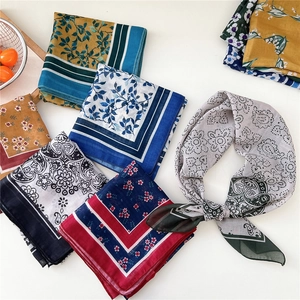 Floral square silk scarf collection with various patterns shown in a flat lay display