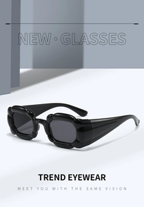 Detail of chunky wave-frame Y2K sunglasses with wide temples and dark lenses