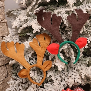 Detail of felt Christmas reindeer antler headbands with brown ears and holiday colors