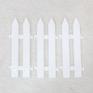 White plastic 3-piece Christmas tree fence picket decoration on faux fur background