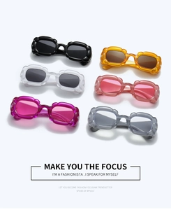 Flat lay of six colorful Y2K pumpkin cloud sunglasses in various trendy jelly colors