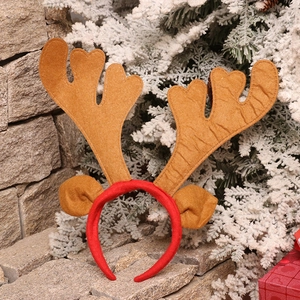 Christmas reindeer antler headband with brown ears on a festive holiday background