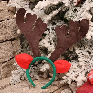 Detail view of brown felt antlers and red ears on a festive Christmas headband accessory