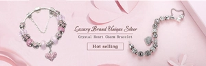 Detailed macro view of pink crystal beads and heart zircon charms on a silver plated bracelet