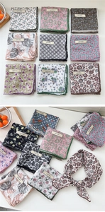 Close-up of assorted paisley cotton linen scarves with elegant crochet lace edges
