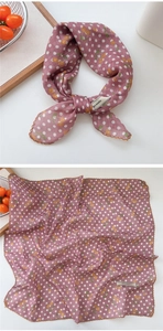 Close-up of pink square scarf with cherry dots and scalloped embroidered edges