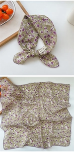 Detail of green floral cotton linen scarf with purple wave edges and woven label