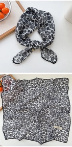 Detail view of paisley print square scarf with delicate black lace trim and monochrome design