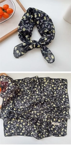 Macro shot of floral lemon print scarf with delicate black wavy lace trim edging