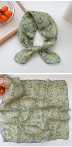 Detail of floral cotton linen square scarf showing blue wave hem and nature style print