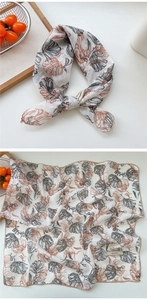 Detail view of cotton-linen feel scarf featuring hand-painted floral patterns and wave edges