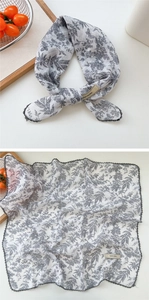 Detailed view of floral cotton-linen scarf with black lace trim and explore infinity tag