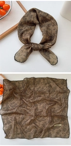 Detail of vintage brown floral scarf with black lace trim and rustic styling